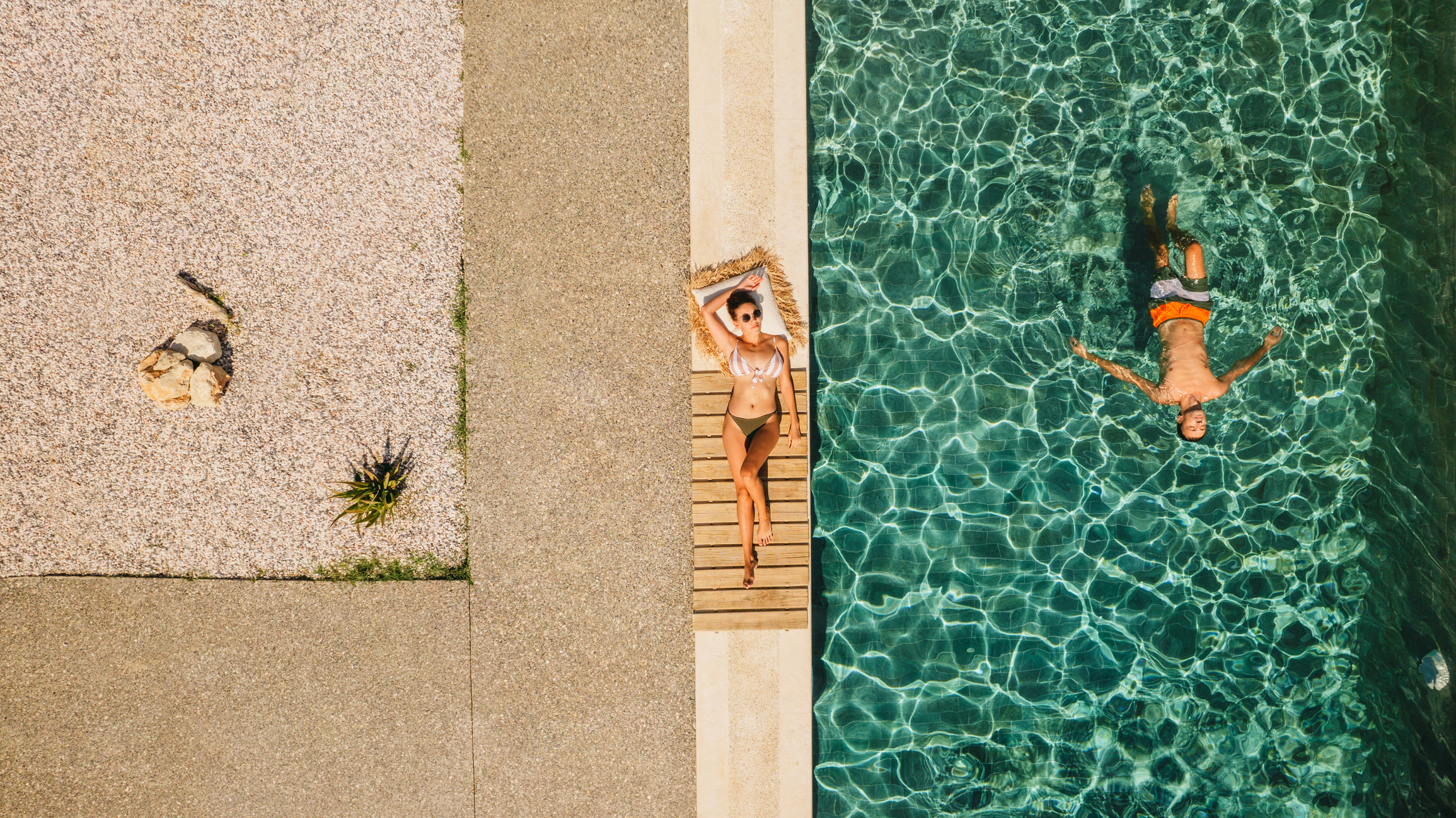 Two people in swimsuits relax and float in a pool, showcasing a hotel marketing collaboration on TikTok.