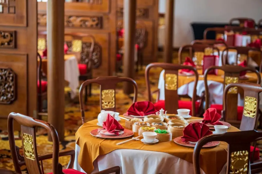 An elegantly designed dining area, featuring tables and chairs in Dynasty Resort, a Bali all-inclusive resort.