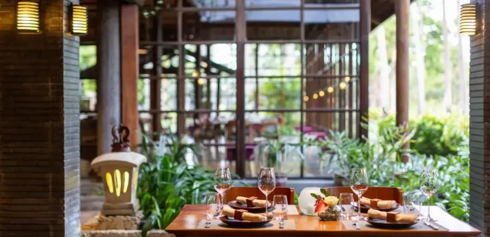 Table and chairs by a window in Melia Bali, showcasing the charm of this Bali resort all-inclusive.