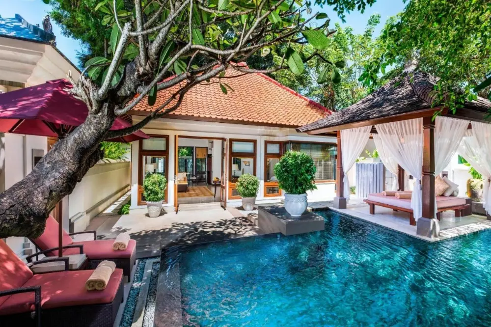 The Laguna villa is surrounded by a vibrant tropical garden, highlighting the charm of the Bali resort all-inclusive.