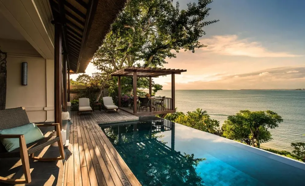 A stunning view of the pool and bay at Four Seasons at Jimbaran Bay, highlighting the resort's elegance and lush landscape.