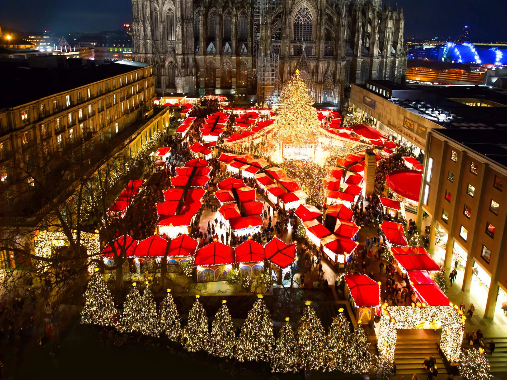 A vibrant Christmas market in Cologne, Germany, filled with tents and twinkling lights, showcasing it as one of the best Christmas markets in Europe.