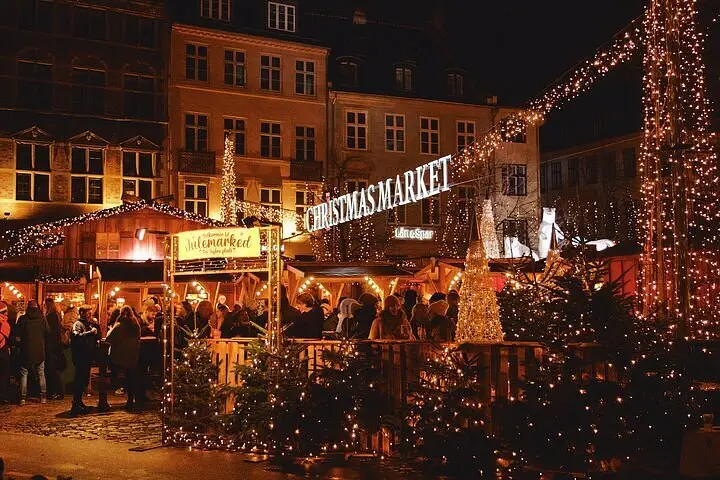 A cosy Christmas market in Copenhagen, Denmark, glowing at night, showcasing it as one of the best Christmas markets in Europe.