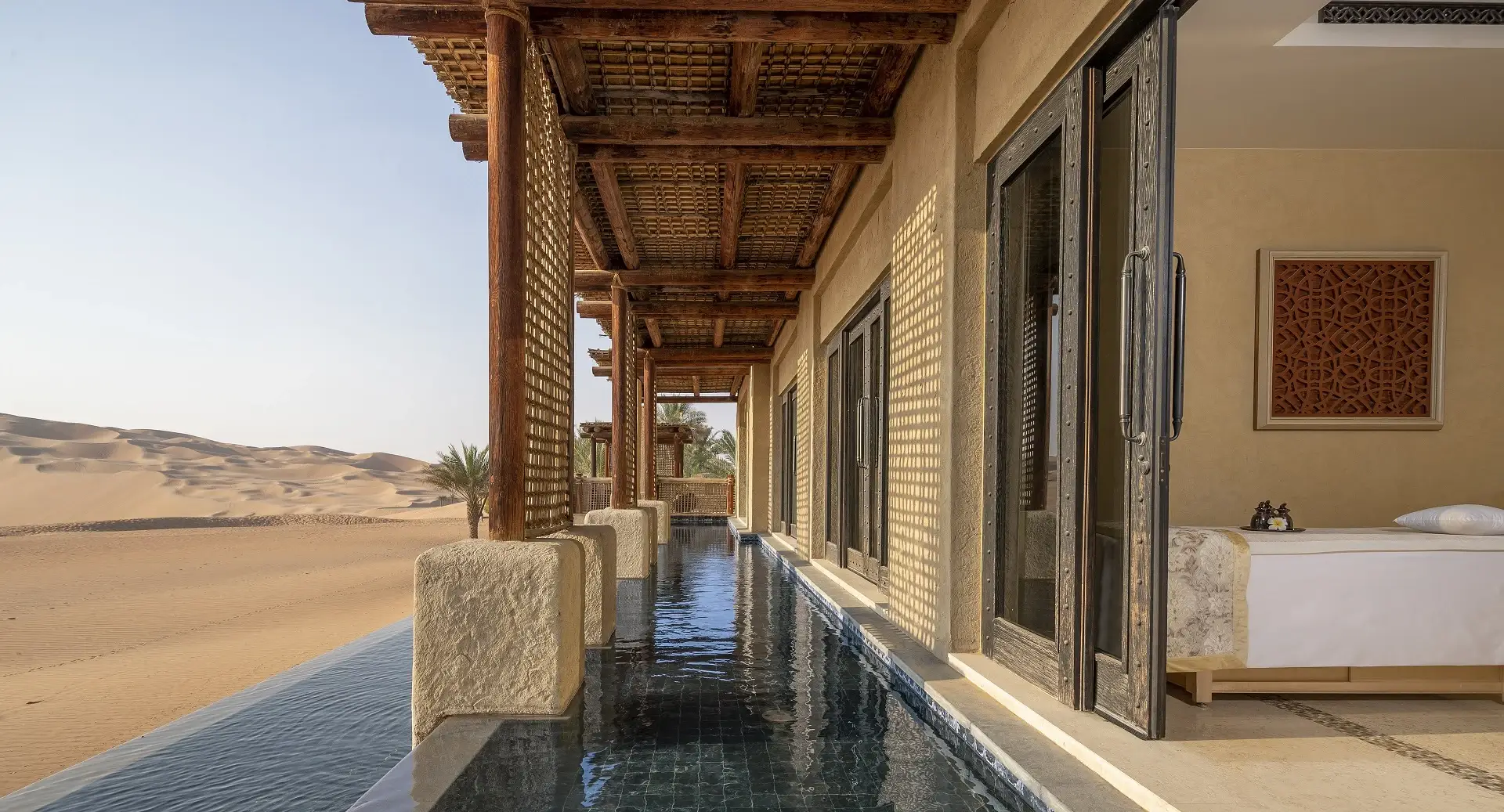 A stunning room at Qasr Al Sarab, one of the best desert hotels worldwide, with a pool and a breathtaking view of the desert.