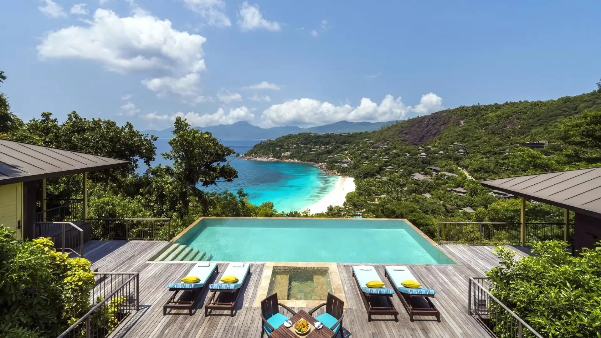 A stunning view of the Four Seasons Resort Seychelles, one of the best Four Seasons hotels in the world, surrounded by lush greenery.