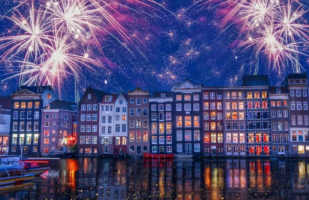 A sky full of colourful fireworks at midnight in front of Dylan, one of the best hotels for New Year’s Eve in Amsterdam.