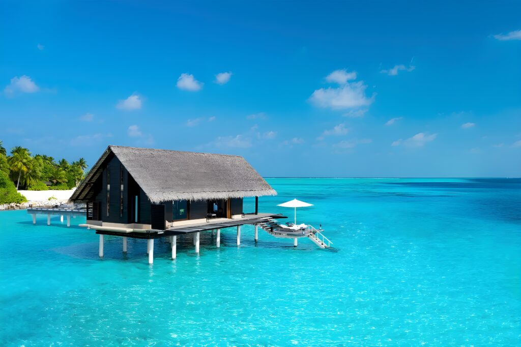 A cozy villa on stilts in the ocean, epitomizing the idyllic setting of One&Only Reethi Rah in the Maldives.