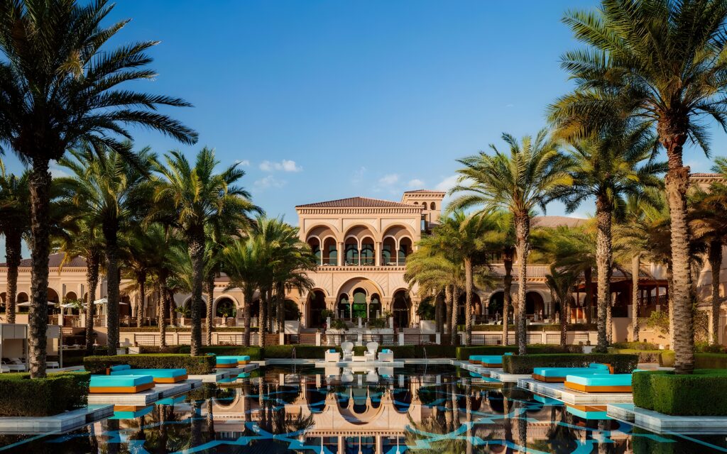 The One&Only The Palm – Dubai, UAE, an exquisite hotel with elegant architecture set against a backdrop of lush greenery.