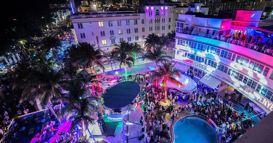 A lively crowd enjoys the night at the Clevelander, one of the best party hotels in Miami, gathered around a sparkling pool.