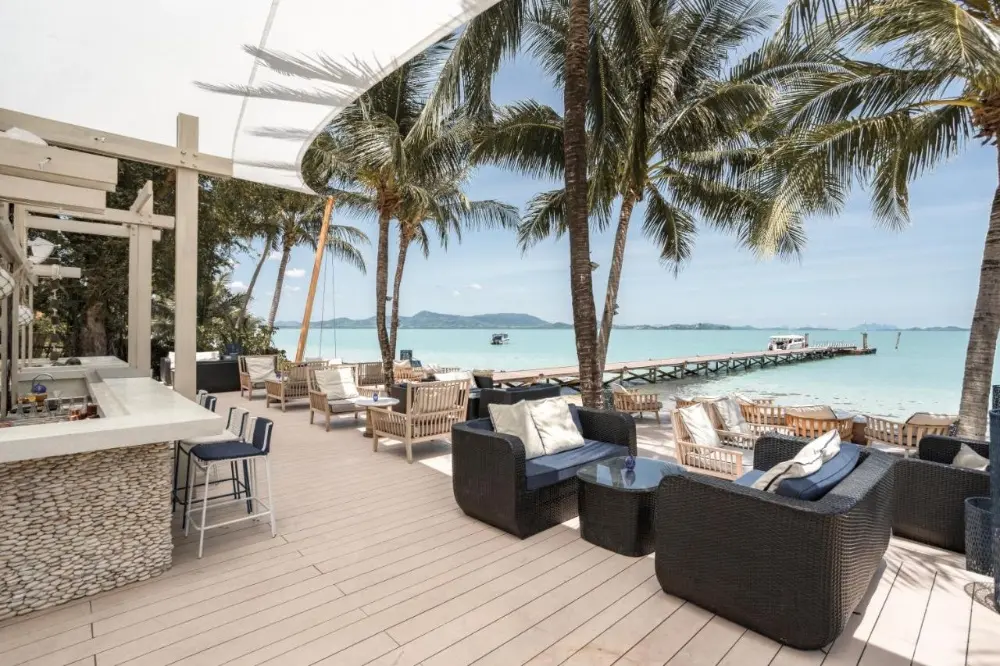 A vibrant beach bar at Barcelo Coconut Island, one of the best resorts in Phuket for couples, offering stunning ocean views.