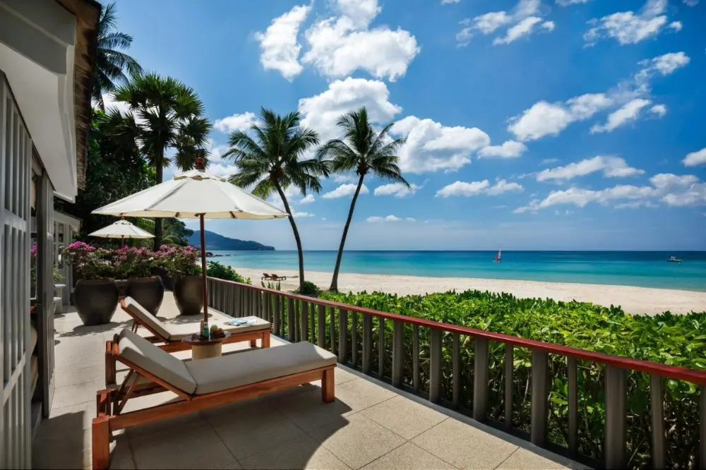 A serene beach view from a terrace at The Surin, one of the best resorts in Phuket for couples, perfect for relaxation and romance.