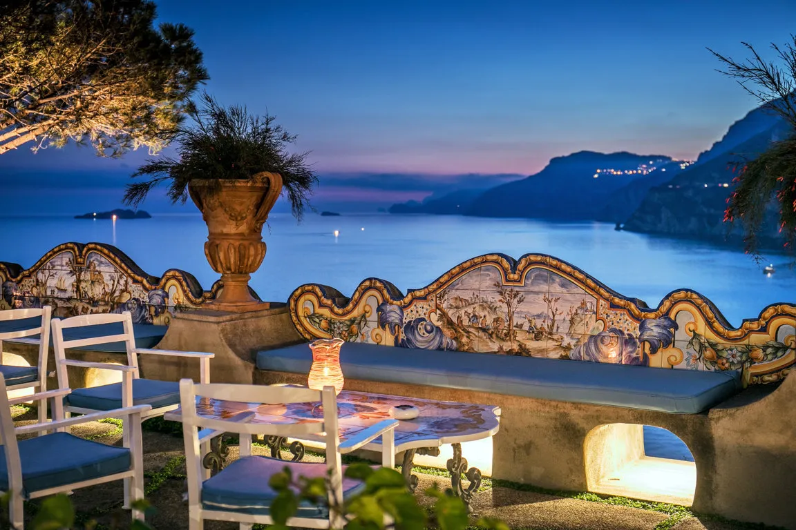 A stunning night view of a terrasse in San Pietro, one of the best romantic hotels in Positano, offering a romantic and memorable stay.