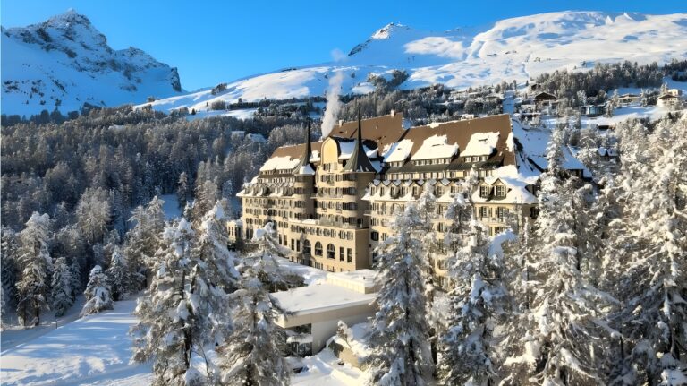 A picturesque grand hotel enveloped in snow, illustrating the allure of best ski hotels in St. Moritz's.