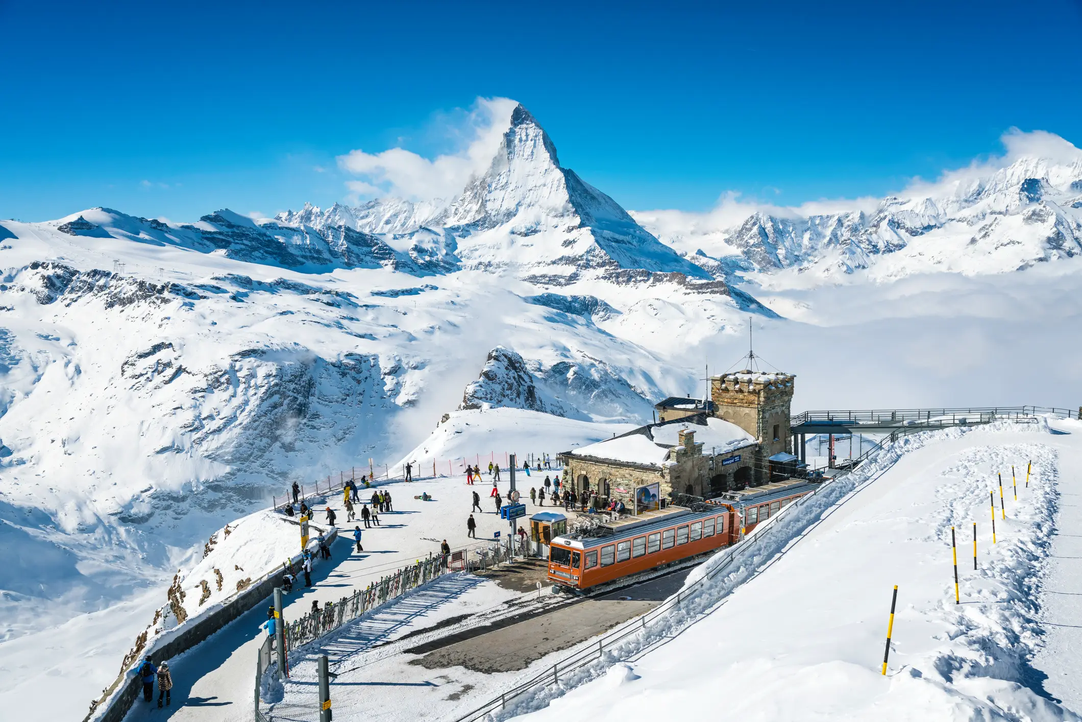 A snowy mountain with a train passing by, showcasing Zermatt, one of the best ski resorts in Switzerland.