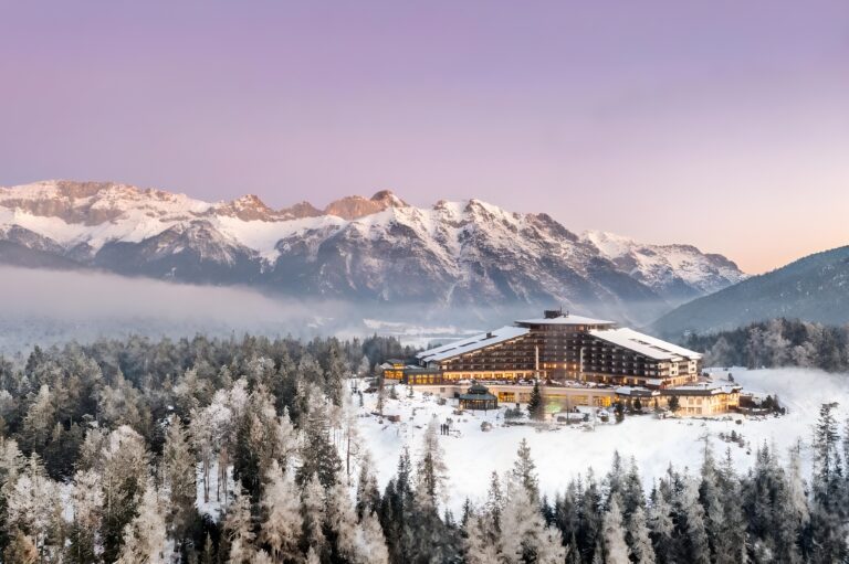 Scenic hotel set amidst snowy trees, perfect for winter sports enthusiasts exploring the best snowboard hotels in Austria.