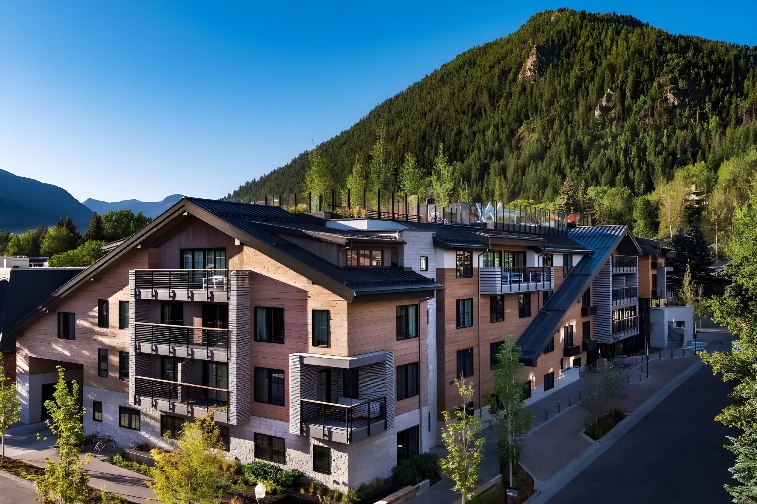 Scenic view of one of the best W hotels in the world enveloped by trees, highlighting the charm of W Aspen.