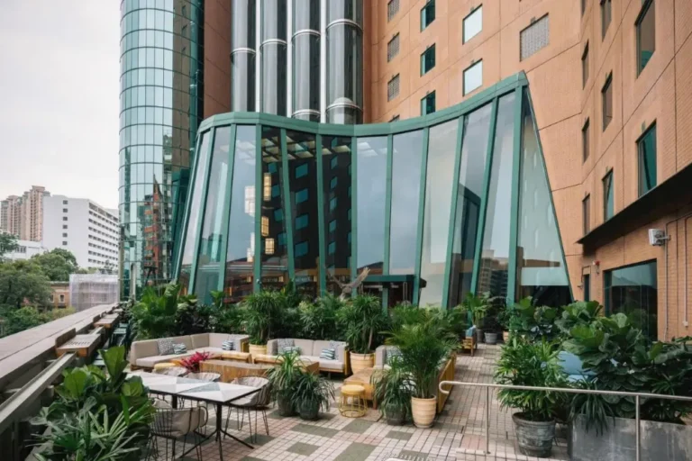 A lush rooftop terrace at one of the best hotels in Hong Kong, surrounded by vibrant plants.