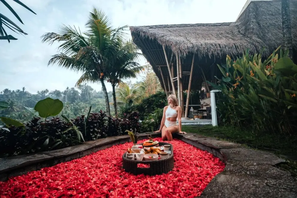 A woman enjoying a beautiful view in a bath from an instagrammable hotel in Bali.