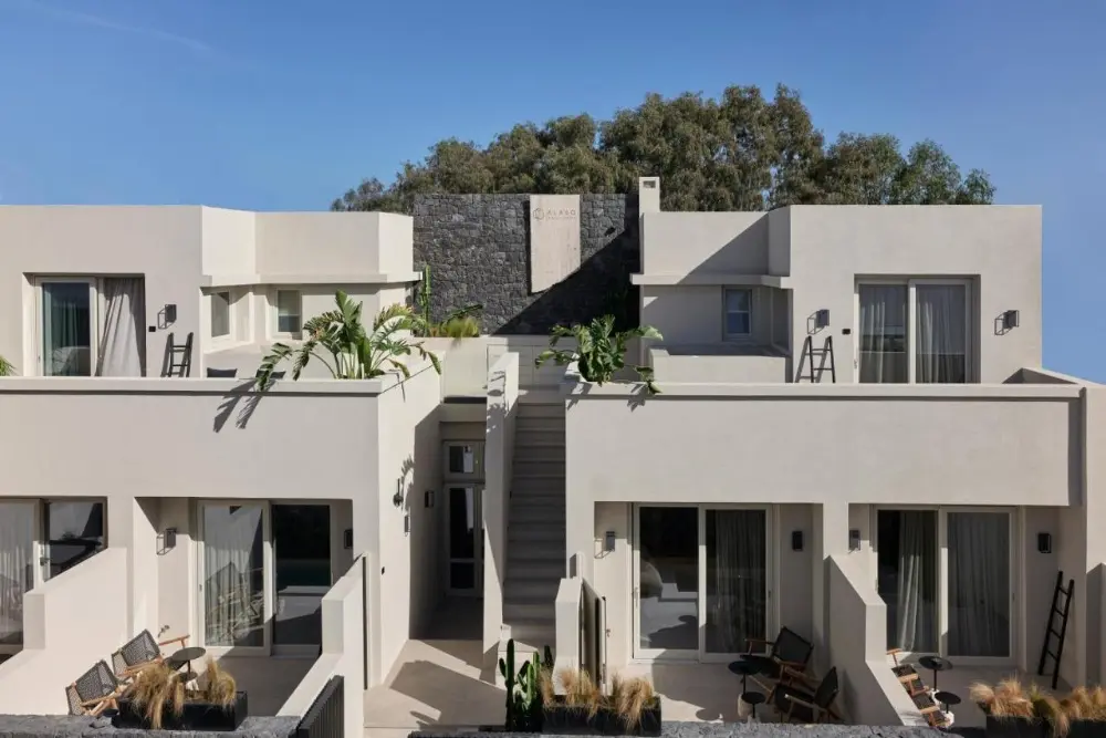 A modern apartment building featuring balconies, showcasing Alaso Design Suites Santorini, a design hotel in Santorini.