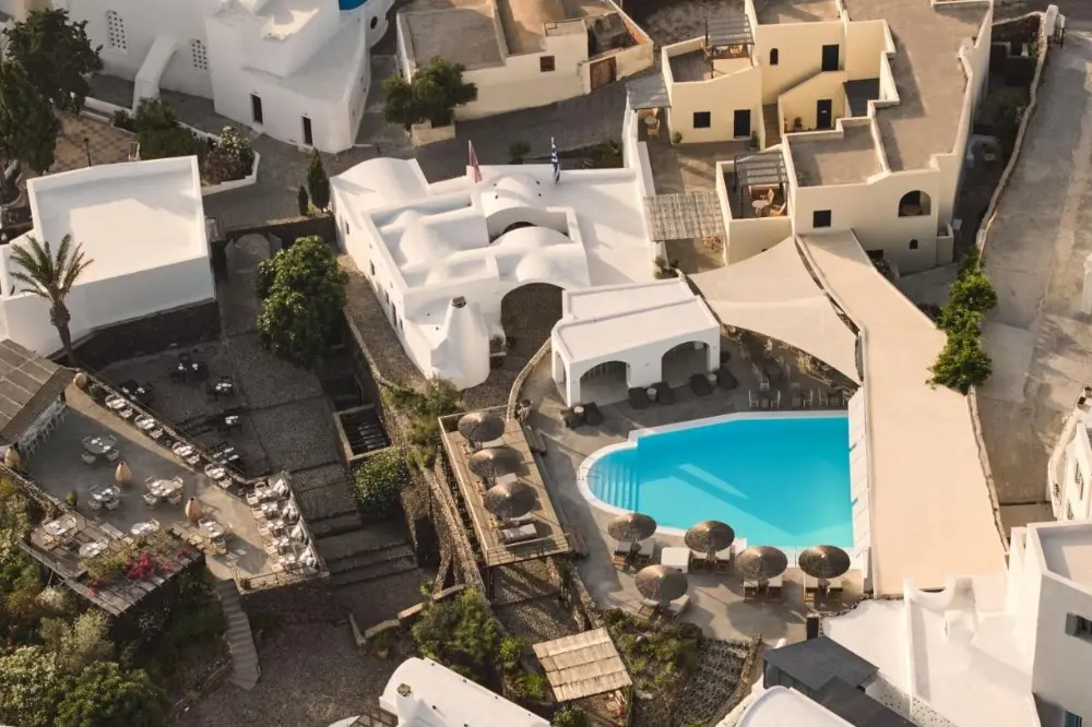 Aerial view of Vedema, Luxury Collection Resort, showcasing a family-friendly hotel in Santorini and its inviting pool