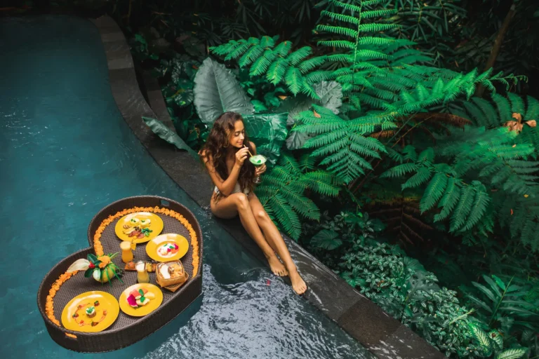 An influencer near a pool showcasing an Instagram post idea for your hotel.