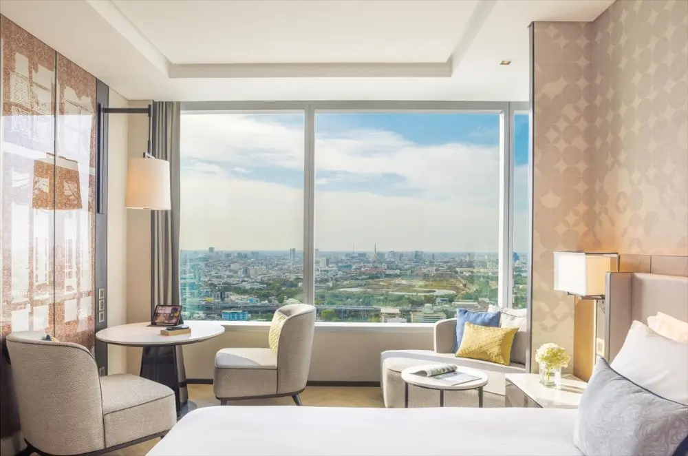 A cosy hotel room at Eastin Grand Hotel Phayathai, a luxury hotel in Bangkok, Thailand, offers a stunning city view.