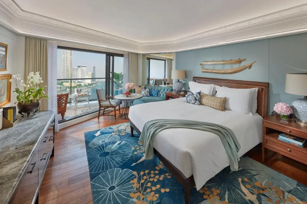 A stunning bedroom at the Mandarin Oriental, a luxury hotel in Bangkok, Thailand, offering a breathtaking view of the city.