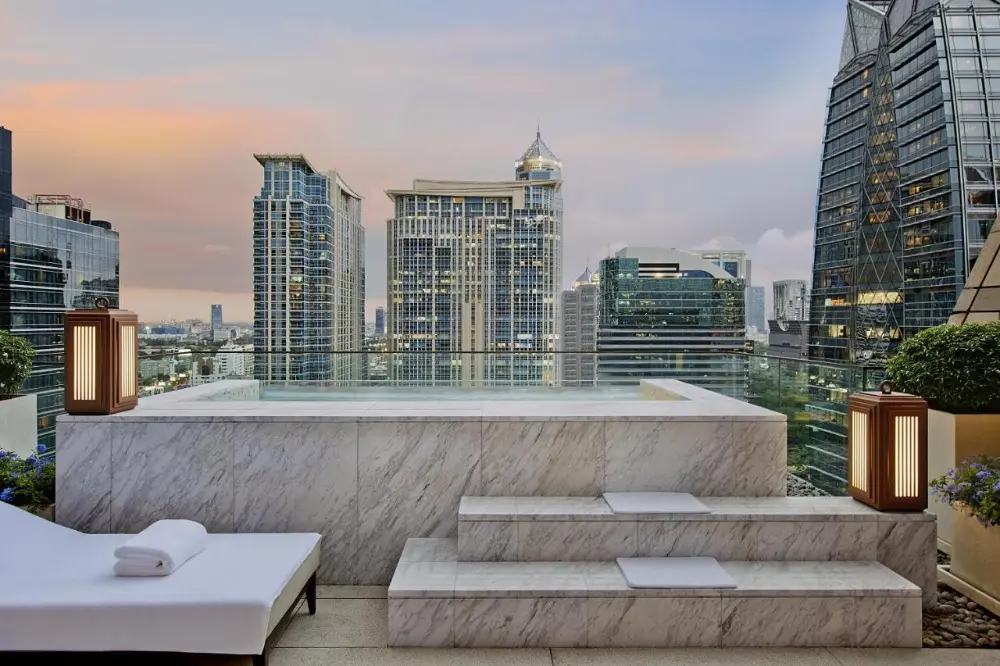 A rooftop pool at Rosewood, a luxury hotel in Bangkok, Thailand, offers stunning city views.