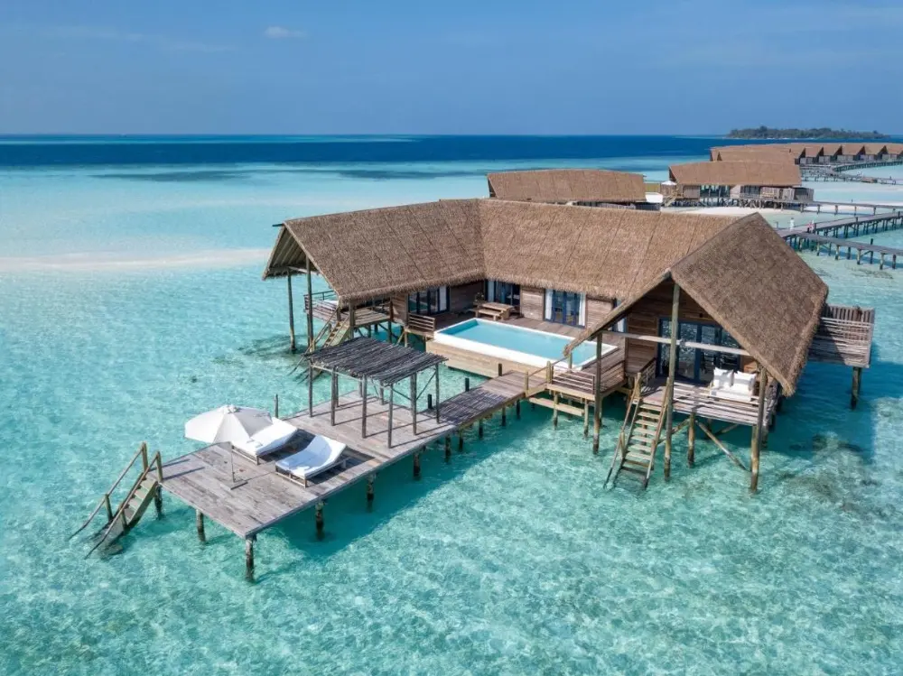 COMO Cocoa Island's overwater bungalows, a luxury resort in Maldives Island, offering luxury and serenity in the breathtaking Maldives landscape.