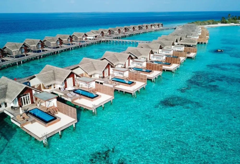 Scenic view of overwater bungalows at Sirru Fen Fushi, a luxury resort in the Maldives, offering tranquility and natural beauty.