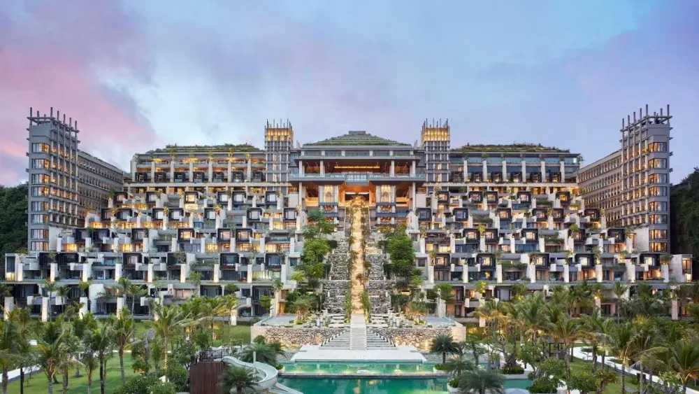 The front of one of the most instagrammable hotels in Bali, The Apurva Kempinski, is surrounded by beautiful palms.