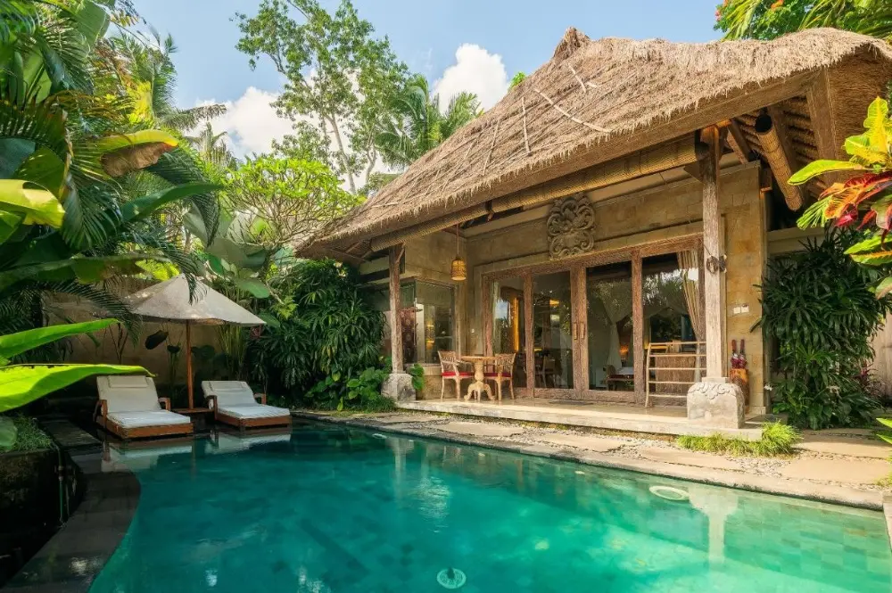 A couple enjoying a luxury time in one of the most instagrammable hotel in Bali. The Udaya Resort & Spa private pool in Bali.