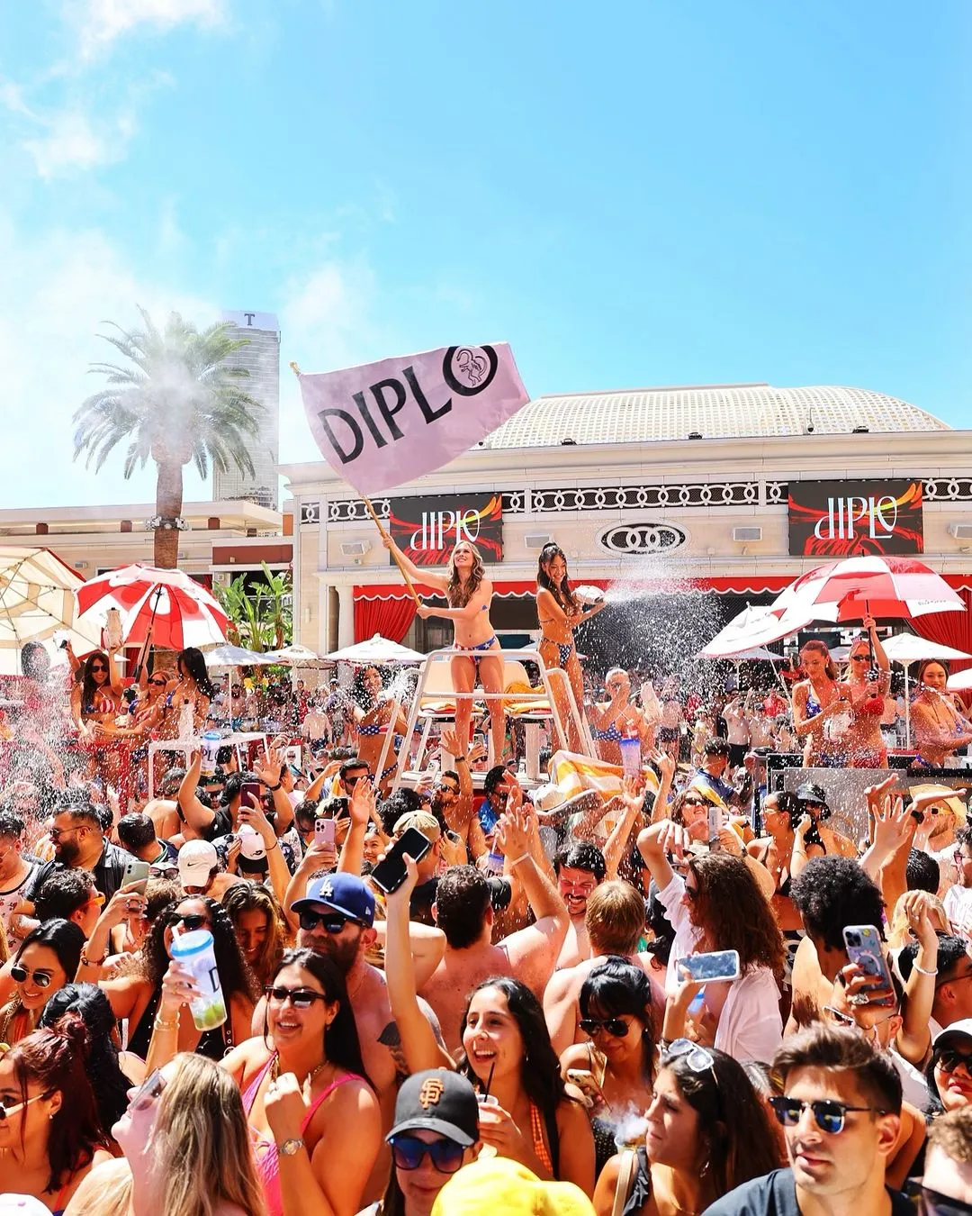 A vibrant gathering of people celebrating at Encore Las Vegas, a party hotel in Las Vegas.