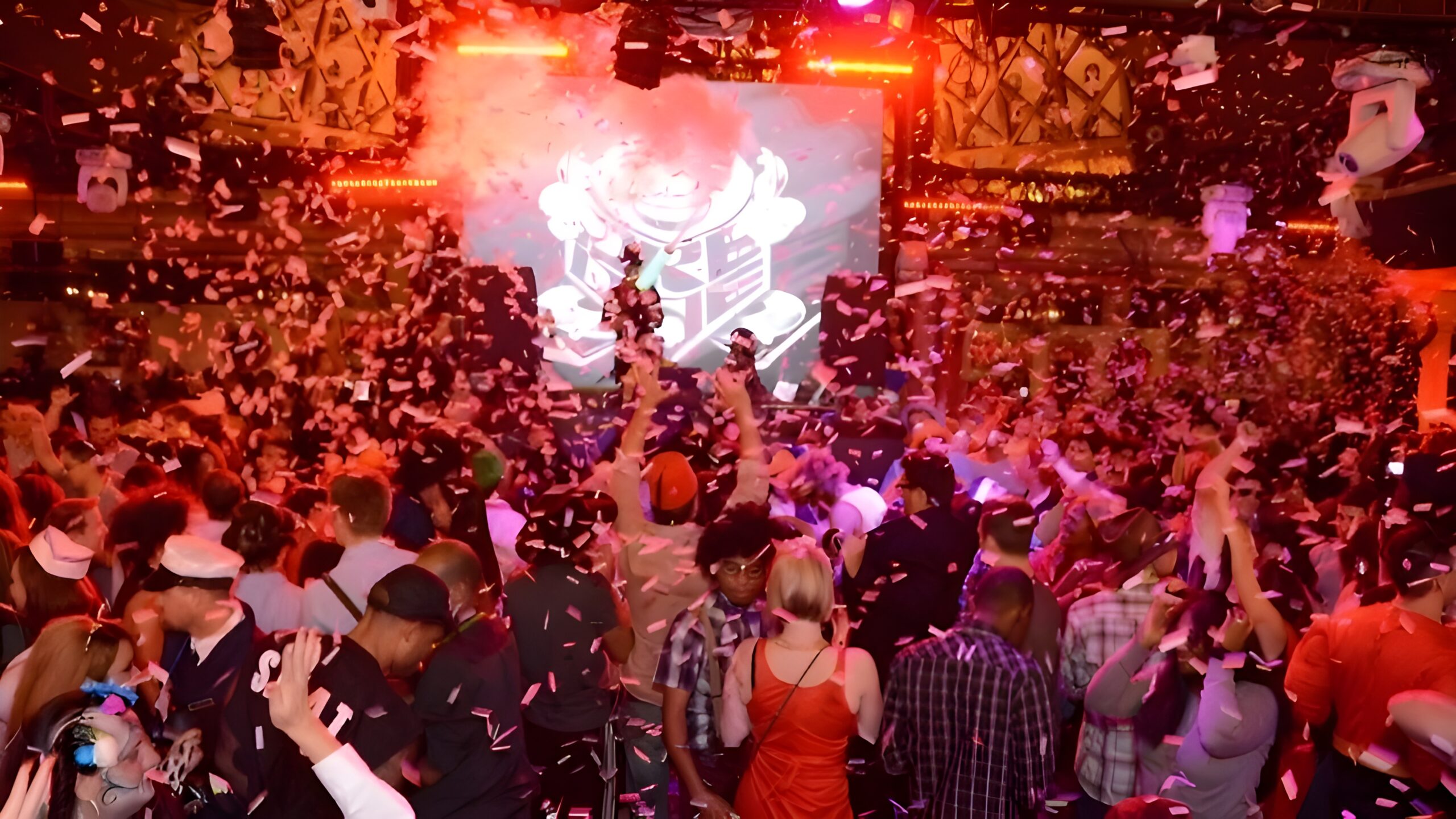 A lively crowd celebrating at a party, surrounded by colorful confetti at Paris Las Vegas Hotel & Casino.