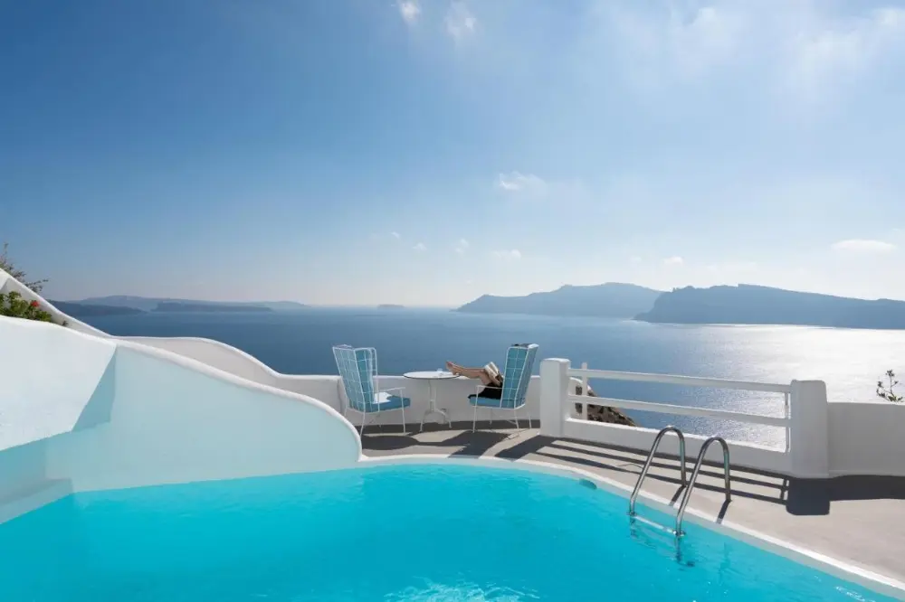 The stunning sea and mountain view from the pool at Katikies Kirini, one of the finest spa hotels in Santorini.