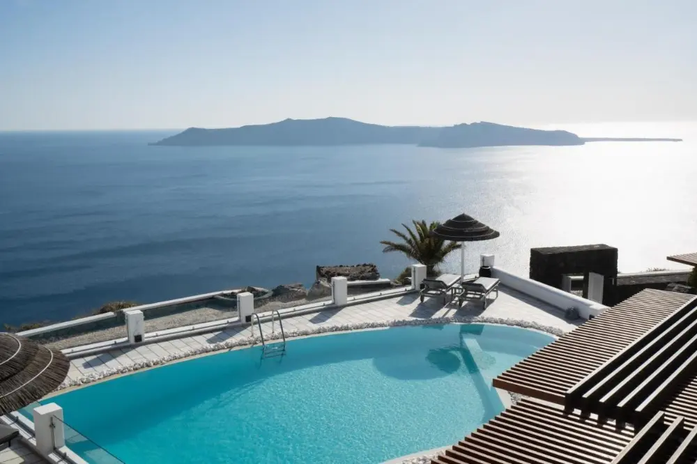 The Princess, a spa hotel in Santorini, offers stunning views of the sea and mountains, and a relaxing swimming pool.