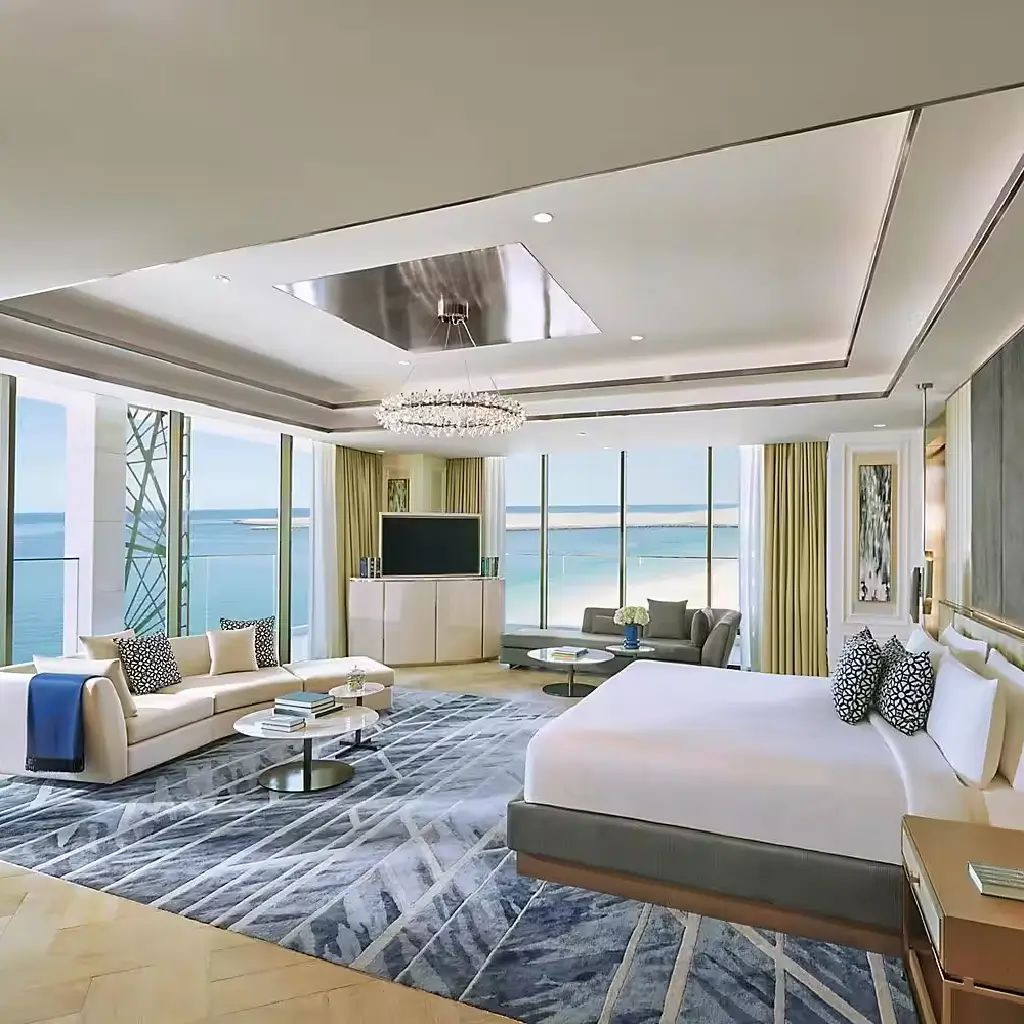 A spacious bedroom in the luxury hotel in Dubai, Mandarin Oriental Jumeirah, featuring stunning ocean views and luxurious decor.